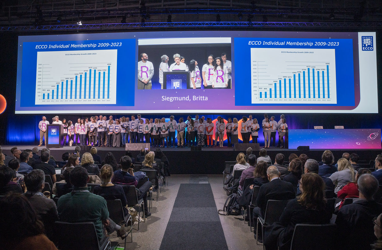behind many people on the ECCO&rsquo;24 stage are graphs and photos displayed on a big screen