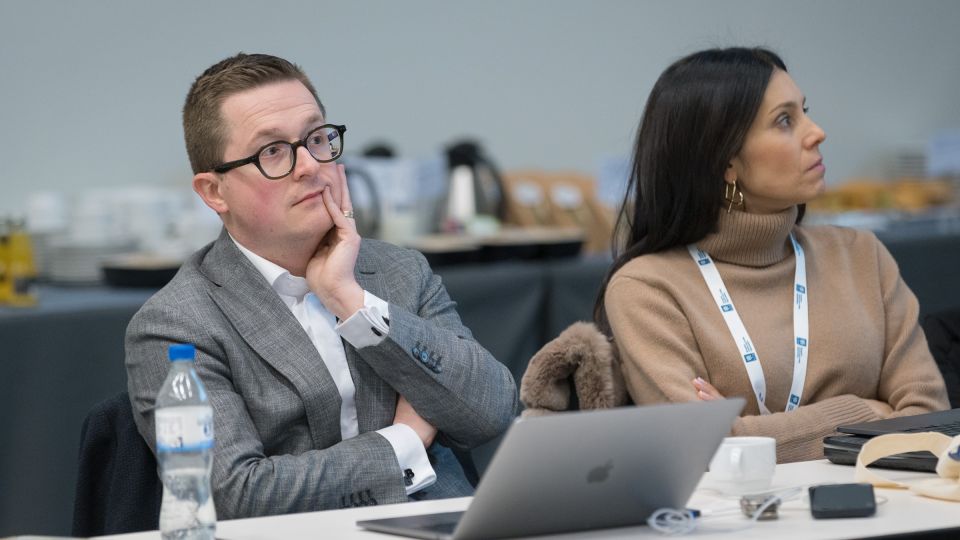 Two members of the operational board listen attentively
