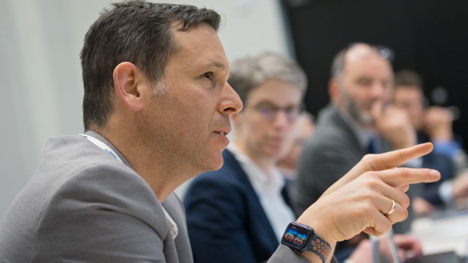 A member of the operational board signs with their hands as they are speaking